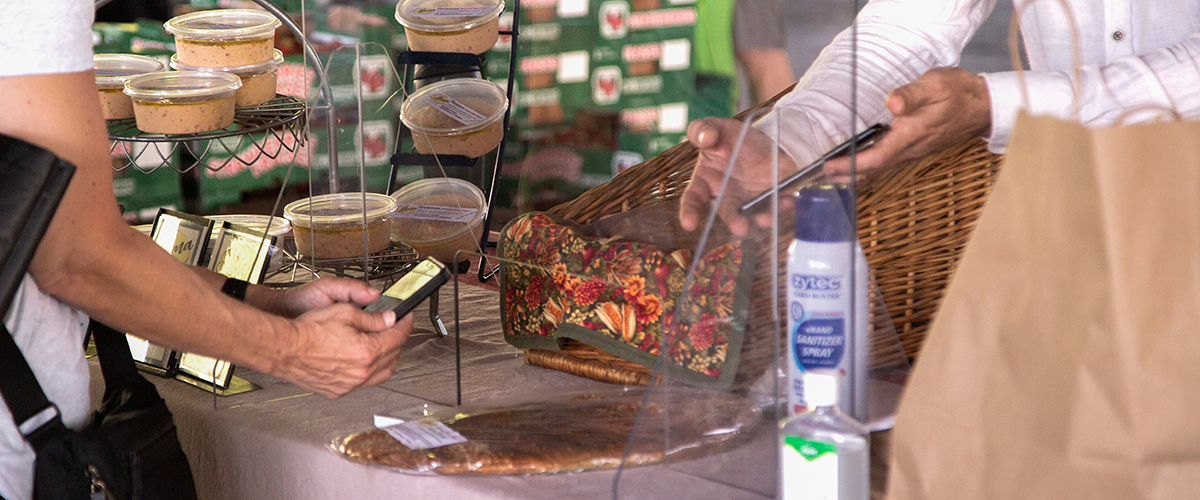 Customer paying with phone for packaged food at the market