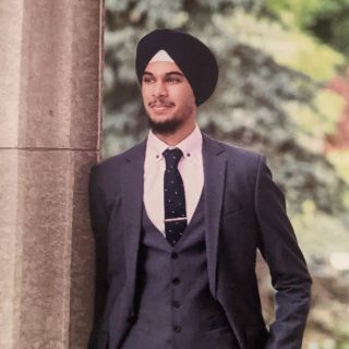 A person standing wearing a suit